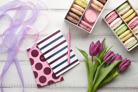 Feminine workspace with macarons and tulipsの写真素材