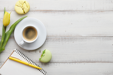 Feminine workspace with coffee and macaronsの写真素材