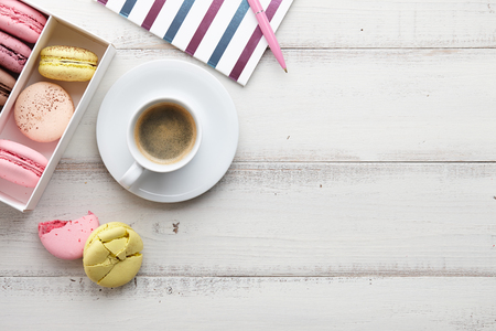 Feminine workspace with coffee and macaronsの写真素材