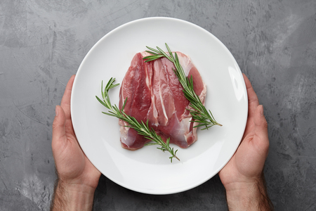 Raw duck breast in white plateの写真素材