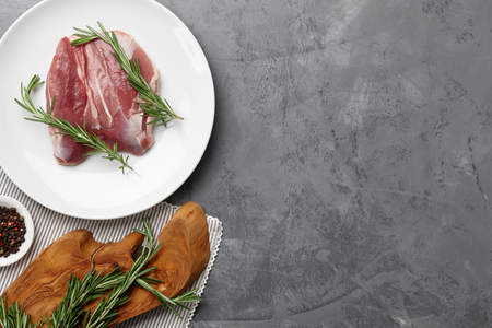 Raw duck breast in white plate with spicesの写真素材