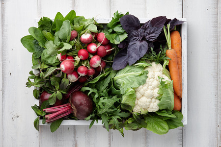 Fresh vegetables and herbs in wooden box