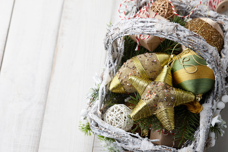 Christmas decorations basket on white planksの写真素材