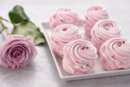 Pink homemade zephyr or marshmallow in plate on gray stone backgroundの写真素材