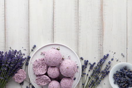 Handmade lavender bath bombs and flowers on white tableの写真素材