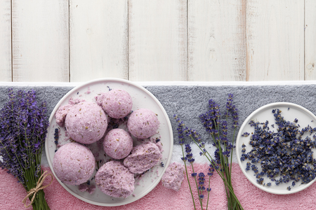 Handmade lavender bath bombs and flowers on white tableの写真素材