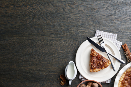 Traditional walnut pie with spices and nuts on dark wooden table, top viewの写真素材