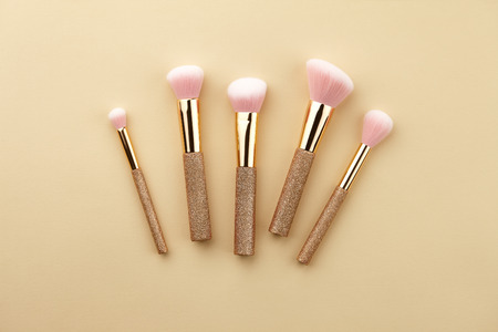 Make up brushes close up on beige background, top viewの写真素材