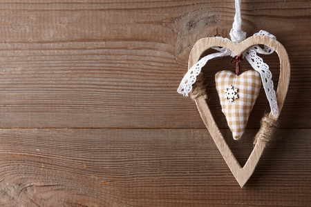 Valentine's day wooden heart toy hanging on old fence, copy spaceの写真素材