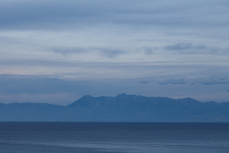 Evening view of Albanian mountains from Greek side. Minimalistic landscape in blue tones.の写真素材