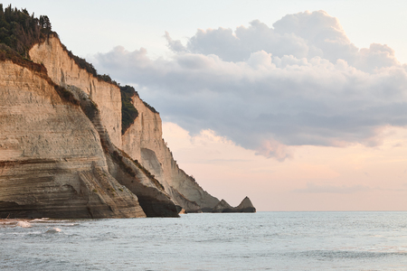 Beautiful coastline with cliffs in Corfu, Greece. Sunset view in Peroulades region.の写真素材