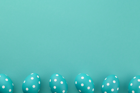 Blue dotted Easter eggs on blue background, copy spaceの写真素材