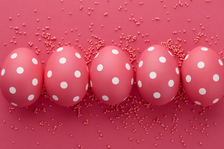Pink dotted Easter eggs on pink background, top view. Holiday concept.の写真素材