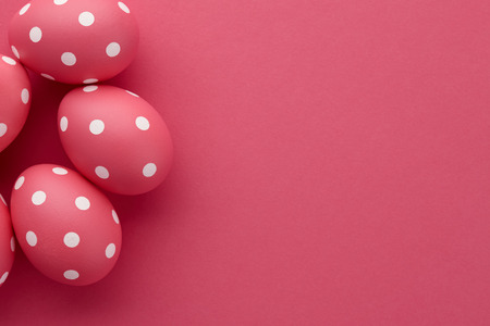 Pink dotted Easter eggs on pink background, top view. Holiday concept.の写真素材