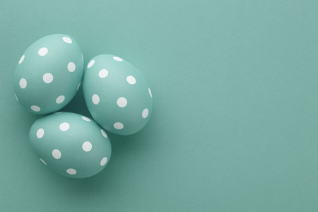 Pastel blue dotted Easter eggs on blue background, copy space. Holiday concept.の写真素材