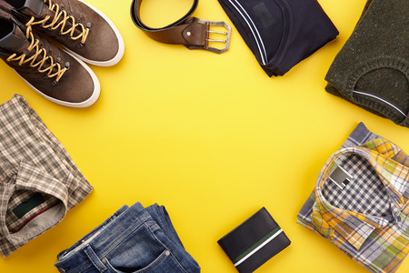 Mens fall casual clothing outfits and accessories flat lay on yellow background, top viewの写真素材