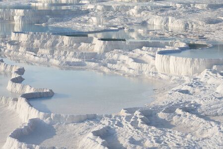 Pamukkale white travertine terraces and thermal pools in sunset, Turkeyの写真素材