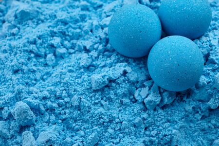Blue bath bombs on dry mixture background, close up viewの写真素材