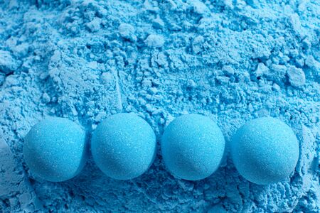 Blue bath bombs on dry mixture background, close up viewの写真素材
