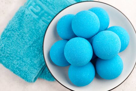 Blue bath bombs in plate on white tabletop, close up viewの写真素材