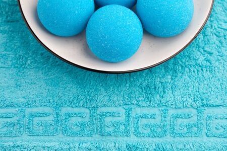 Blue bath bombs in plate on towel background, copy spaceの写真素材