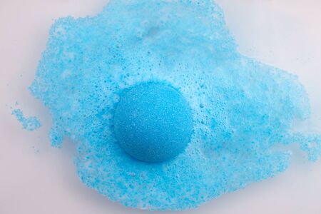 Blue bath bomb foaming in water, close up viewの写真素材