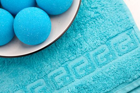 Blue bath bombs in plate on towel background, copy spaceの写真素材