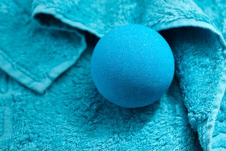 Blue bath bomb on towel background, close up viewの写真素材
