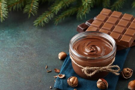 Chocolate spread or nougat cream with hazelnuts in Christmas timeの写真素材