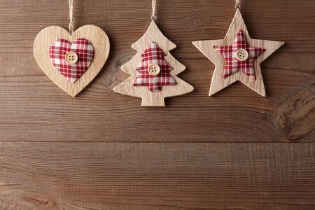 Christmas toys hanging on wooden background, copy spaceの写真素材