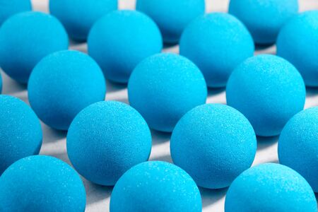 Blue bath bombs pattern on white tabletop, hard shadowsの写真素材