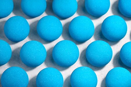 Blue bath bombs pattern on white tabletop, hard shadowsの写真素材