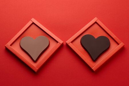 Valentines day chocolate hearts in red box on red background, copy spaceの写真素材