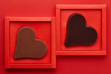 Valentines day chocolate hearts in red box on red background, copy spaceの写真素材