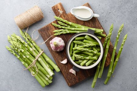 Fresh green asparagus on wooden cutting board, gourmet cookingの写真素材