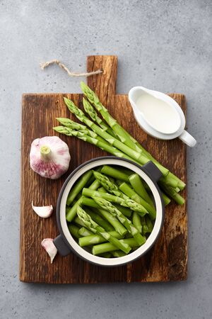 Fresh green asparagus on wooden cutting board, gourmet cookingの写真素材