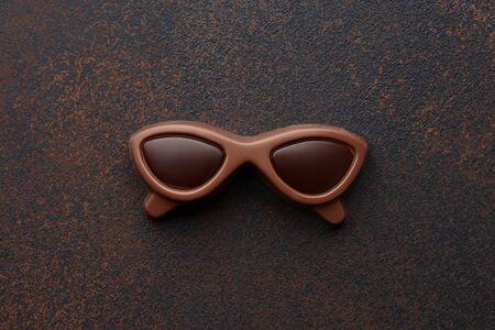 Chocolate sunglasses on textured brown background, women's or mother's day holiday conceptの写真素材