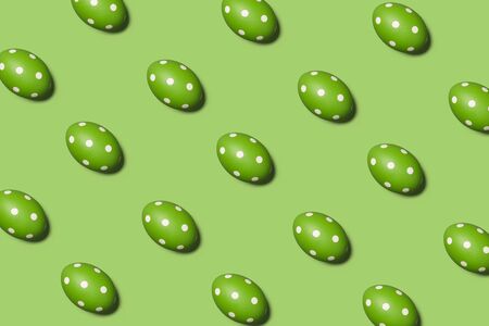 Trendy Easter pattern with green eggs in dots on green background, holiday conceptの写真素材