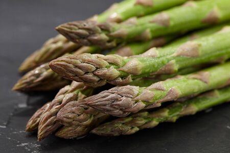 Fresh green asparagus on stone background, close up viewの写真素材