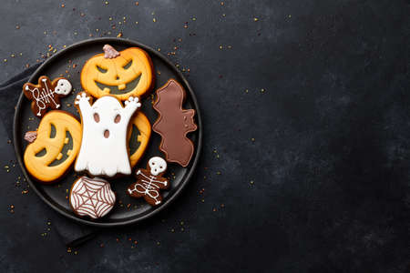 Funny Halloween gingerbread biscuits on black backgroundの写真素材
