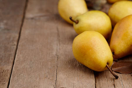 Yellow pears on wooden table, close up viewの写真素材