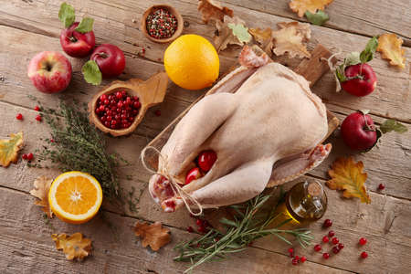 Raw turkey cooking for Thanksgiving dinner. Holiday preparation.の写真素材