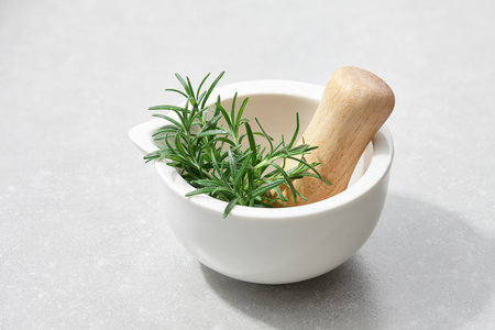 Fresh rosemary in mortar, close up viewの写真素材