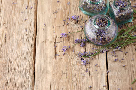 Dried lavender in glass jars on wooden backgroundの写真素材