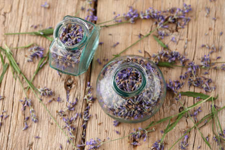 Dried lavender in glass jars on wooden backgroundの写真素材