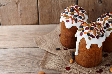 Easter cakes with candied fruits and nuts on wooden backgroundの写真素材