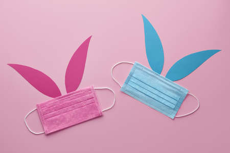 Easter bunnies made from blue and pink protective face masks. Holiday creative concept.の写真素材