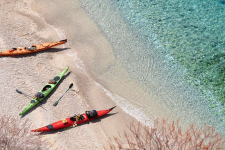 Colorful kayaks on azure sea coast in Albaniaの写真素材