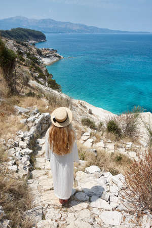Woman in hat looking at beautiful, Shpella e Pellumbave, Albania.