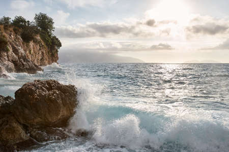 Adriatic sea waves and cliffs at sunset in Vlora, Albania